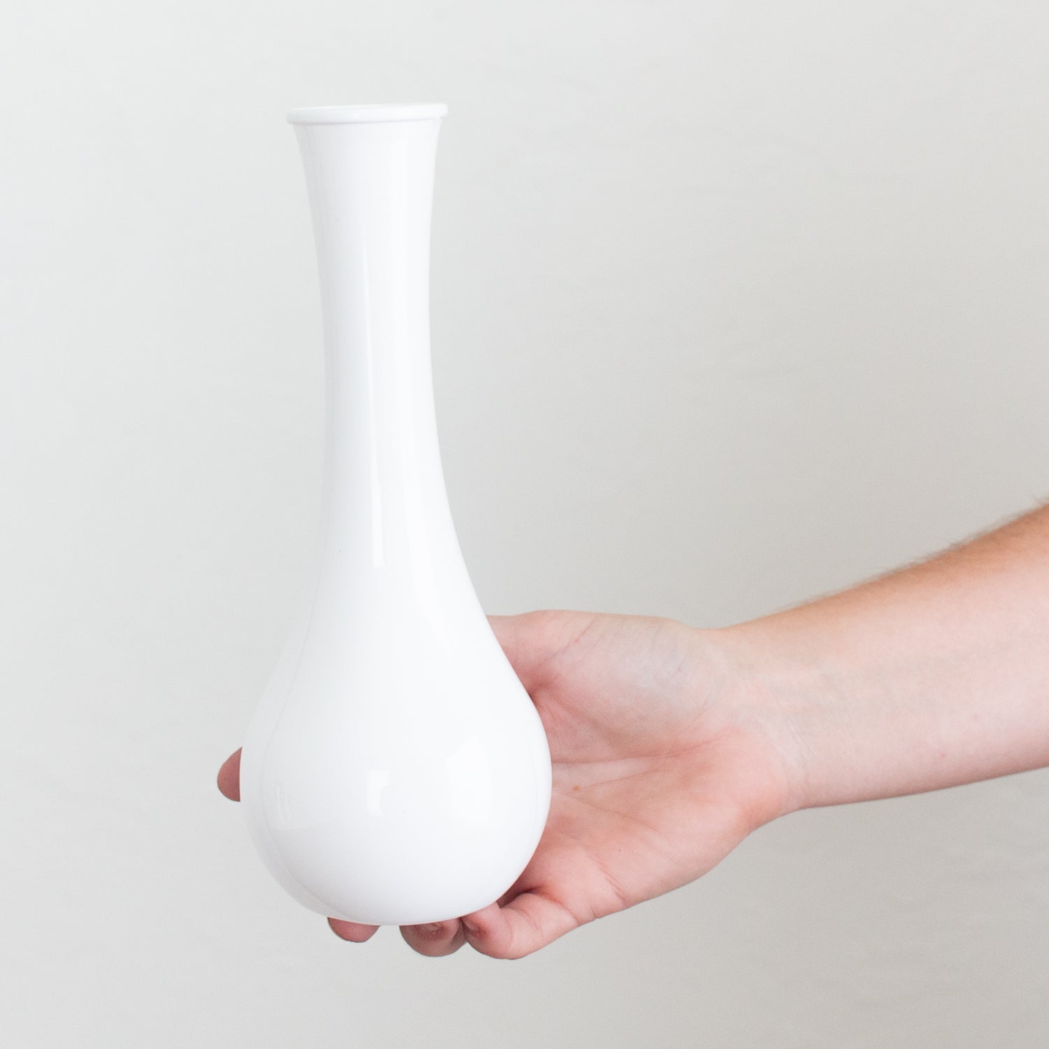 white plastic bud vase