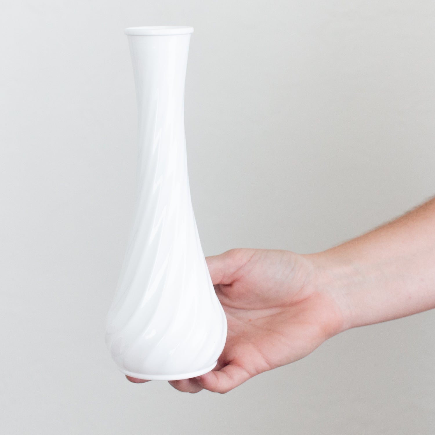 white plastic bud vase