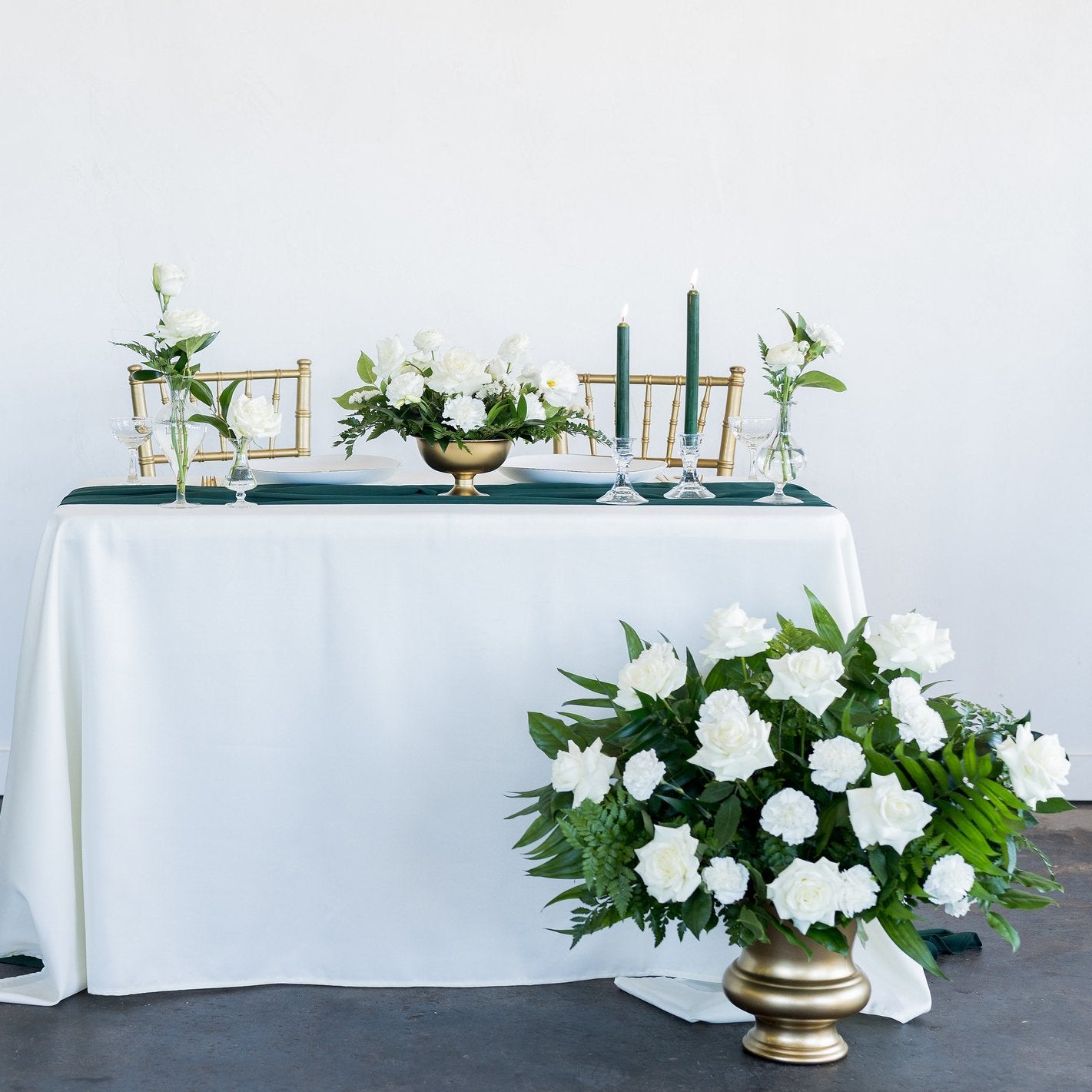 White and green wedding centerpiece with gold vases