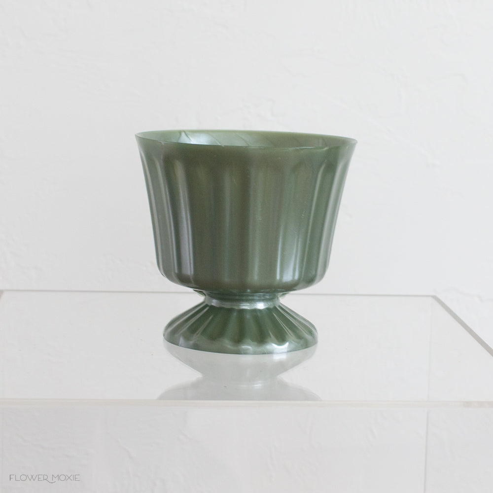 footed green plastic vase