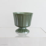 footed green plastic vase